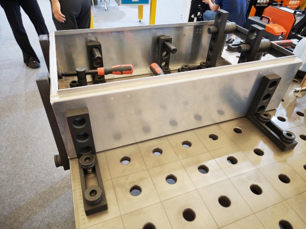 Clamps on a SWJIG 3D welding table securely hold metal sheets in place during welding, preventing movement and distortion. This ensures precise alignment and consistent weld quality, enhancing efficiency and accuracy throughout the fabrication process. Adjustable clamps accommodate various sizes and shapes for versatile use.